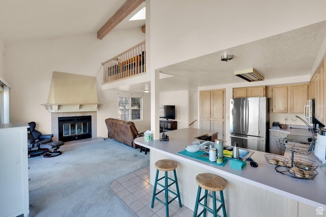 882 Schneitter Cir, Midway, UT 84049 - kitchen featuring freestanding refrigerator, light brown cabinetry, light colored carpet, open floor plan, and a peninsula