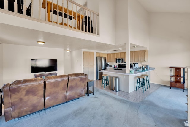 882 Schneitter Cir, Midway, UT 84049 - living room featuring a towering ceiling, light carpet, light tile patterned floors, and baseboards