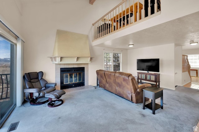 882 Schneitter Cir, Midway, UT 84049 - carpeted living room with a tile fireplace, a towering ceiling, healthy amount of natural light, and baseboards