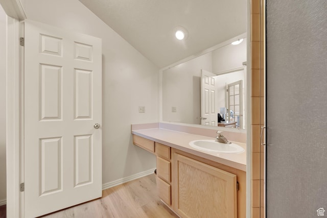882 Schneitter Cir, Midway, UT 84049 - bathroom featuring lofted ceiling, vanity, wood finished floors, and baseboards