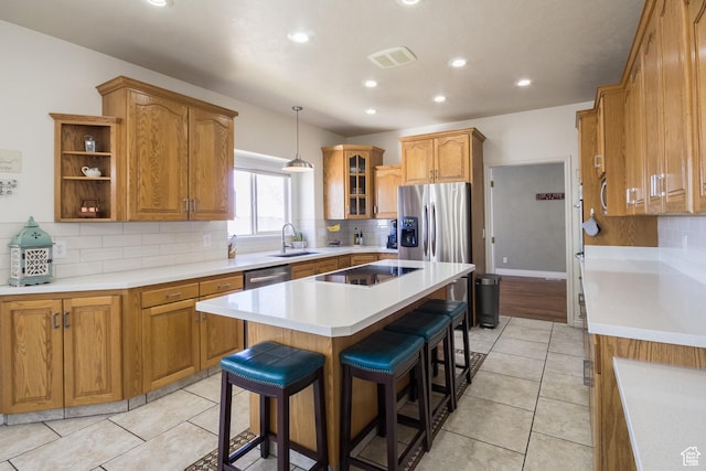 414 S 3130 W, Vernal, UT 84078 - kitchen with visible vents, a breakfast bar, a kitchen island, appliances with stainless steel finishes, and a sink