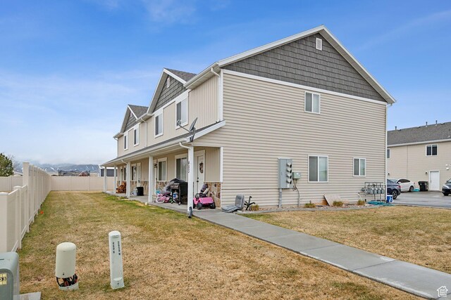 483 N 2650 W Unit 6, Tremonton, UT 84337 - view of side of property with a patio, a shingled roof, fence, and a yard