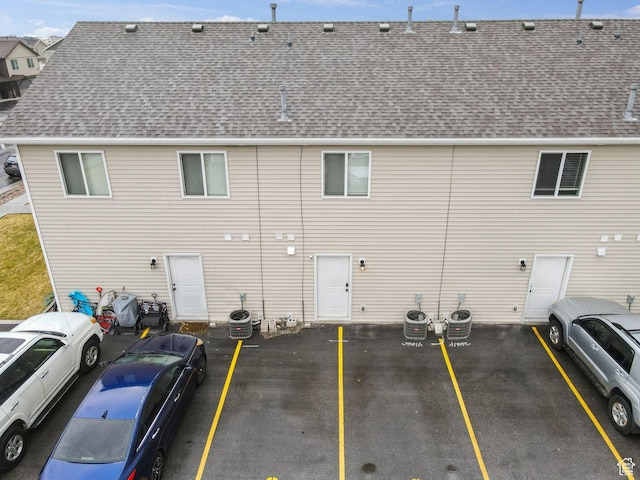 483 N 2650 W Unit 6, Tremonton, UT 84337 - back of property with central AC, a shingled roof, and uncovered parking