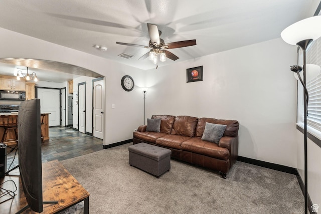 483 N 2650 W Unit 6, Tremonton, UT 84337 - living area with dark carpet, baseboards, visible vents, arched walkways, and ceiling fan