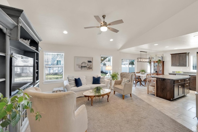 living room with lofted ceiling, recessed lighting, and a ceiling fan