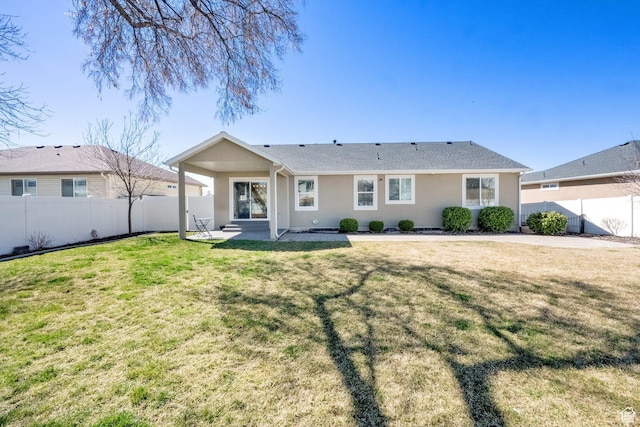 back of property with a lawn, a fenced backyard, a patio, and stucco siding