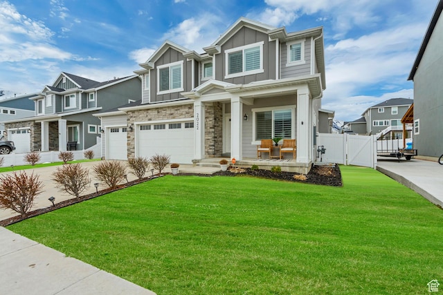 craftsman inspired home featuring stone siding, board and batten siding, a gate, and a residential view