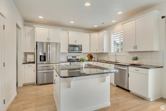 2022 E 970 N, Spanish Fork, UT 84660 - kitchen featuring appliances with stainless steel finishes, a sink, light wood-style floors, white cabinetry, and recessed lighting