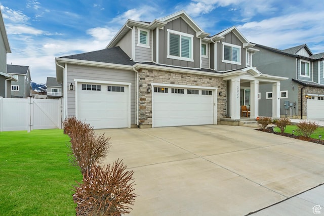 2022 E 970 N, Spanish Fork, UT 84660 - craftsman-style house featuring board and batten siding, concrete driveway, a gate, a garage, and stone siding