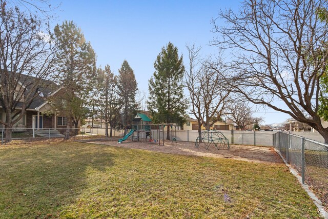 view of yard featuring a fenced backyard and playground community