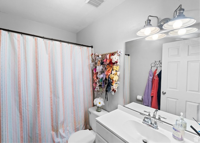 bathroom with visible vents, toilet, and vanity