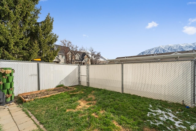 view of yard with a gate and a fenced backyard