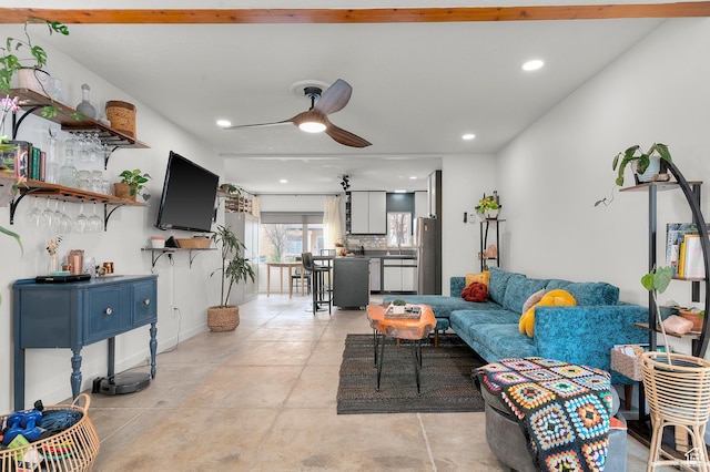 living room featuring baseboards, concrete floors, recessed lighting, and a ceiling fan