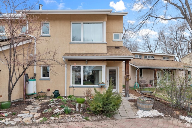 back of house with stucco siding