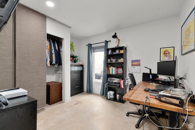 office with recessed lighting and concrete flooring
