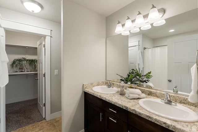 259 W 40 N, Hyrum, UT 84319 - bathroom with double vanity, a spacious closet, and baseboards