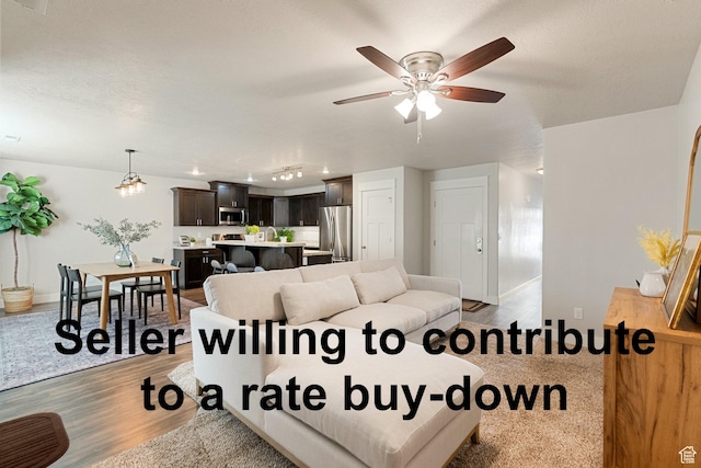 259 W 40 N, Hyrum, UT 84319 - living room featuring light wood-type flooring, baseboards, and ceiling fan