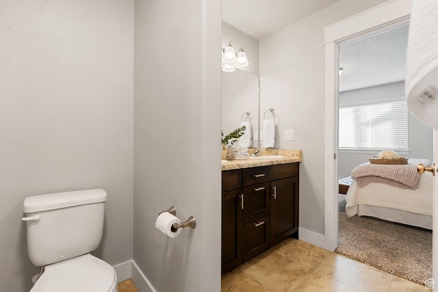 259 W 40 N, Hyrum, UT 84319 - bathroom with vanity, toilet, ensuite bath, baseboards, and tile patterned floors