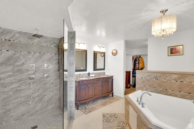 bathroom featuring double vanity, tile patterned floors, tiled shower, a bath, and a sink