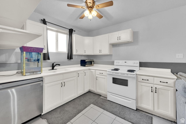 kitchen featuring a sink, ceiling fan, white cabinetry, stainless steel appliances, and light tile patterned flooring