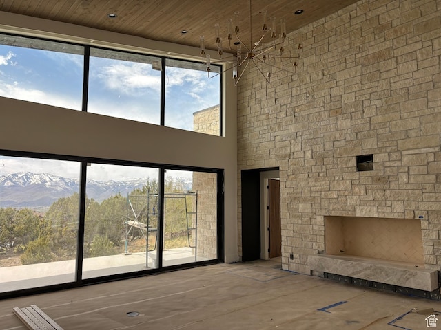 2220 E Flat Top Mountain Dr, Heber City, UT 84032 - unfurnished living room featuring a high ceiling, plenty of natural light, a fireplace, wood ceiling, and a mountain view