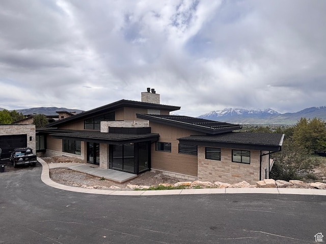 2220 E Flat Top Mountain Dr, Heber City, UT 84032 - view of front facade featuring a mountain view, a chimney, and stone siding
