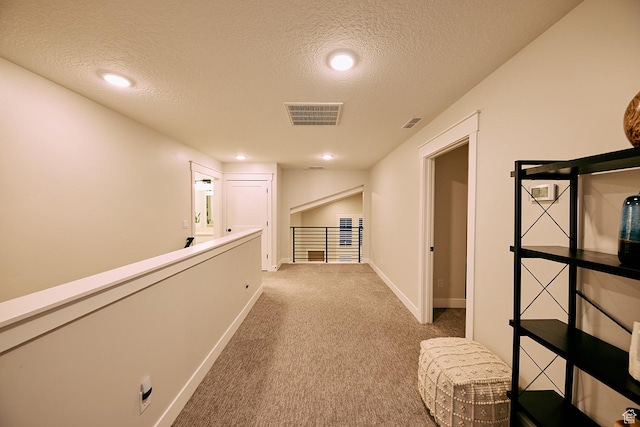 6889 W Lake Ave, South Jordan, UT 84009 - hallway with baseboards, visible vents, carpet, and a textured ceiling
