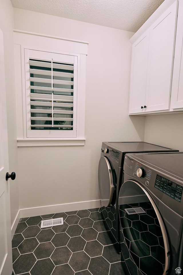 6889 W Lake Ave, South Jordan, UT 84009 - laundry room featuring baseboards, washing machine and dryer, cabinet space, and a textured ceiling