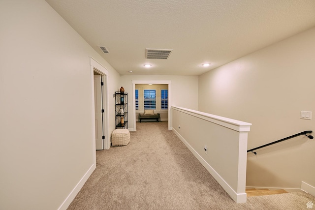 6889 W Lake Ave, South Jordan, UT 84009 - hall with light colored carpet, visible vents, an upstairs landing, and baseboards