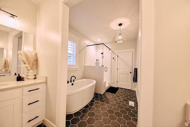 6889 W Lake Ave, South Jordan, UT 84009 - full bathroom featuring a soaking tub, baseboards, tile patterned floors, vanity, and a stall shower