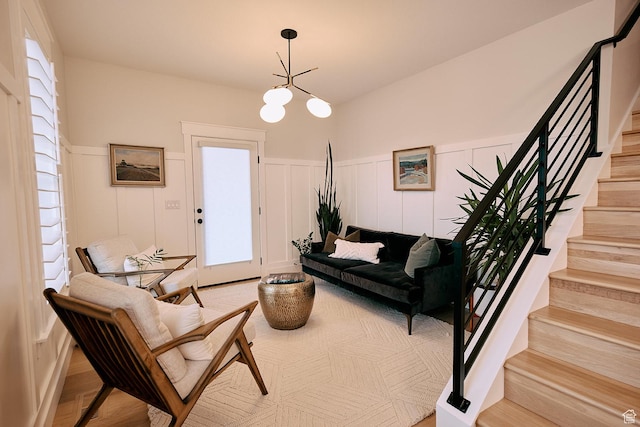 6889 W Lake Ave, South Jordan, UT 84009 - living area with a wainscoted wall, stairs, a decorative wall, and a chandelier