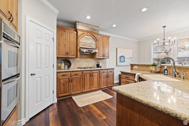 6208 W Bull River Rd, Highland, UT 84003 - kitchen featuring a sink, stainless steel appliances, a chandelier, decorative backsplash, and crown molding