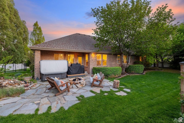 6208 W Bull River Rd, Highland, UT 84003 - rear view of property featuring brick siding, a patio, an outdoor fire pit, and a shingled roof