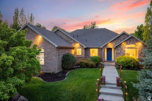 6208 W Bull River Rd, Highland, UT 84003 - view of front of home with brick siding, a lawn, a shingled roof, and stone siding