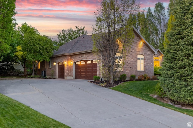 6208 W Bull River Rd, Highland, UT 84003 - view of front of property with brick siding, a garage, driveway, a yard, and cooling unit