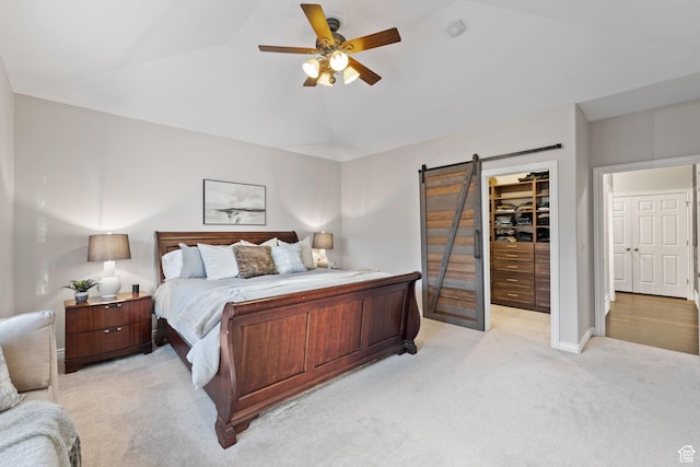 6208 W Bull River Rd, Highland, UT 84003 - bedroom featuring light colored carpet, a walk in closet, a closet, ceiling fan, and a barn door