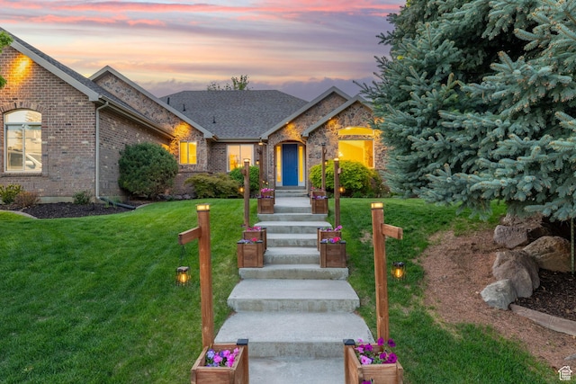 6208 W Bull River Rd, Highland, UT 84003 - view of front of house featuring a lawn, brick siding, and a shingled roof