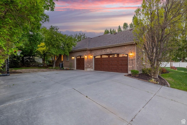 6208 W Bull River Rd, Highland, UT 84003 - view of front of house featuring concrete driveway, brick siding, a garage, and roof with shingles