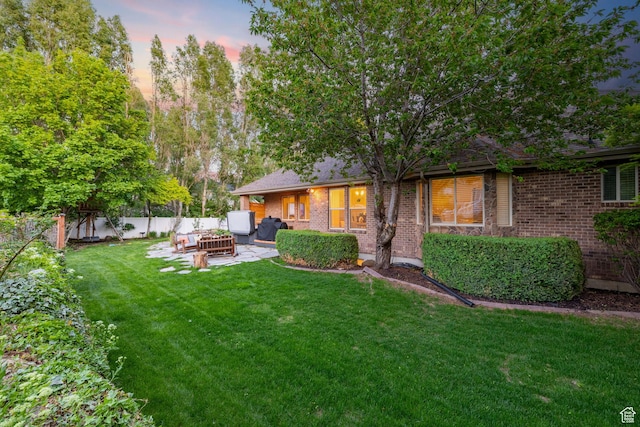 6208 W Bull River Rd, Highland, UT 84003 - yard at dusk with outdoor lounge area and a patio area