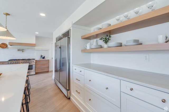881 S 635 W, Orem, UT 84058 - kitchen featuring white cabinets, open shelves, high end appliances, and light wood-type flooring
