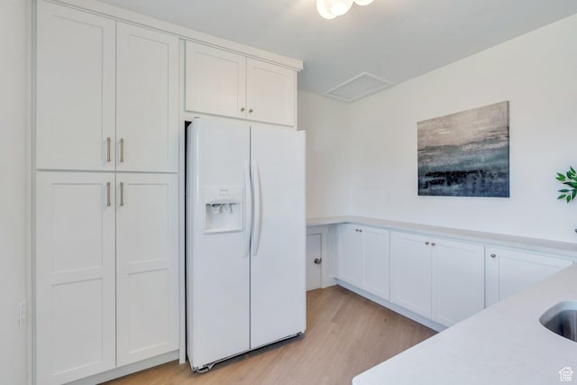 881 S 635 W, Orem, UT 84058 - kitchen with white refrigerator with ice dispenser, light countertops, white cabinetry, and light wood finished floors