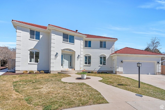 881 S 635 W, Orem, UT 84058 - mediterranean / spanish-style home featuring driveway, an attached garage, a front lawn, and brick siding