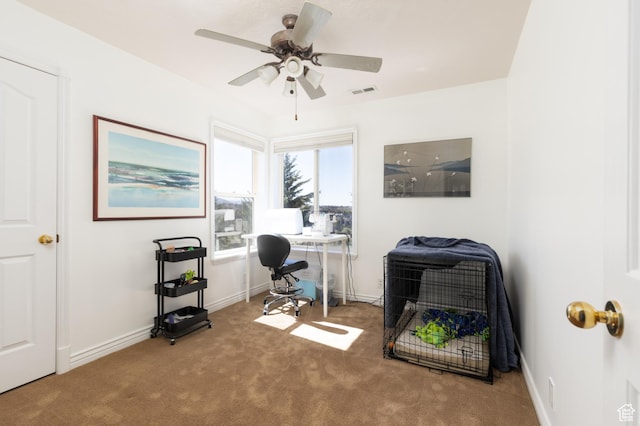 home office with baseboards, carpet flooring, ceiling fan, and visible vents