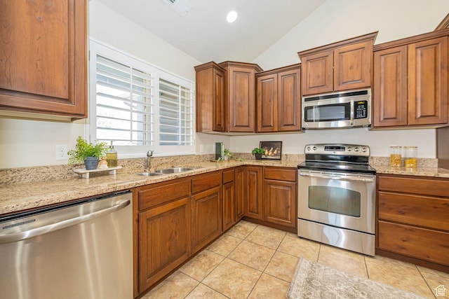 1886 S 830 W Unit D, Syracuse, UT 84075 - kitchen with brown cabinets, stainless steel appliances, lofted ceiling, a sink, and light tile patterned floors