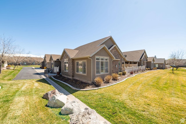 1886 S 830 W Unit D, Syracuse, UT 84075 - view of front of house featuring stucco siding, stone siding, and a front lawn