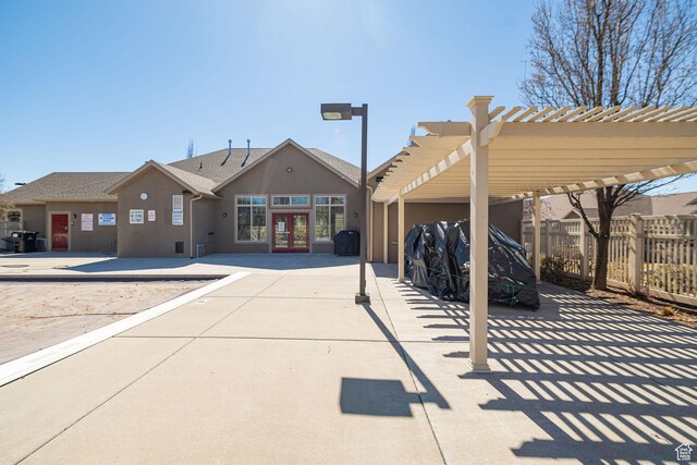 1886 S 830 W Unit D, Syracuse, UT 84075 - exterior space featuring french doors, stucco siding, fence, a pergola, and a shingled roof