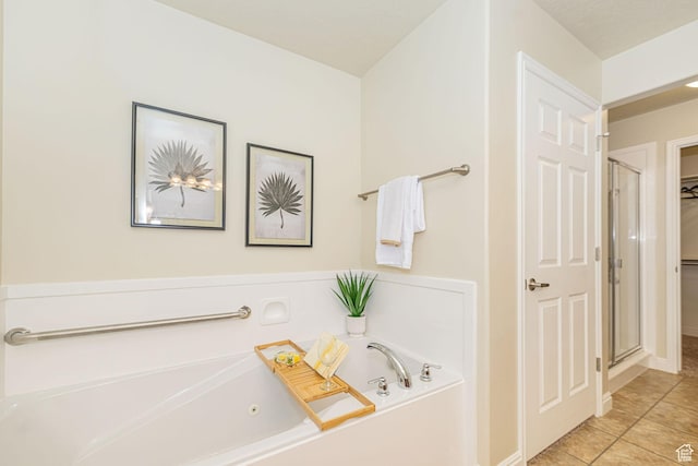 1886 S 830 W Unit D, Syracuse, UT 84075 - full bath featuring a shower stall, a whirlpool tub, a walk in closet, tile patterned flooring, and baseboards