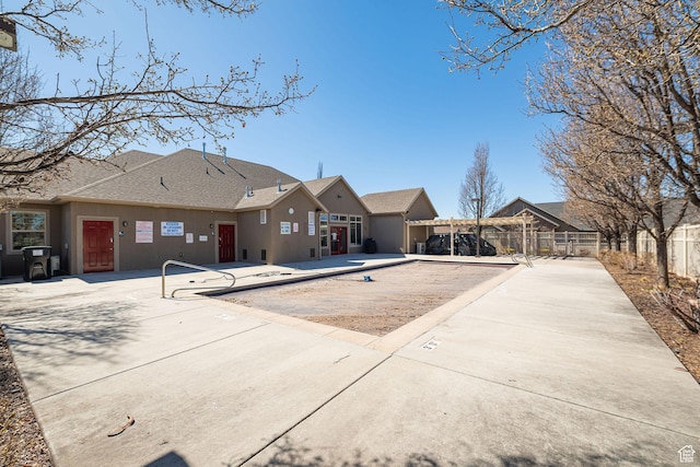 1886 S 830 W Unit D, Syracuse, UT 84075 - rear view of property featuring a shingled roof, stucco siding, fence, and a patio