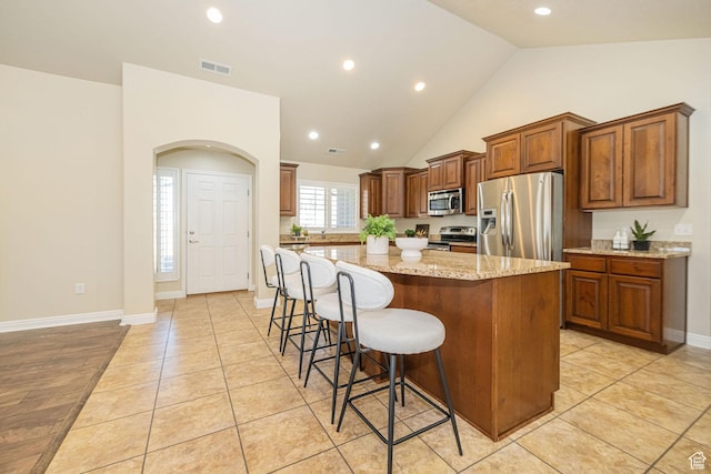 1886 S 830 W Unit D, Syracuse, UT 84075 - kitchen with a kitchen breakfast bar, stainless steel appliances, a center island, visible vents, and light stone countertops