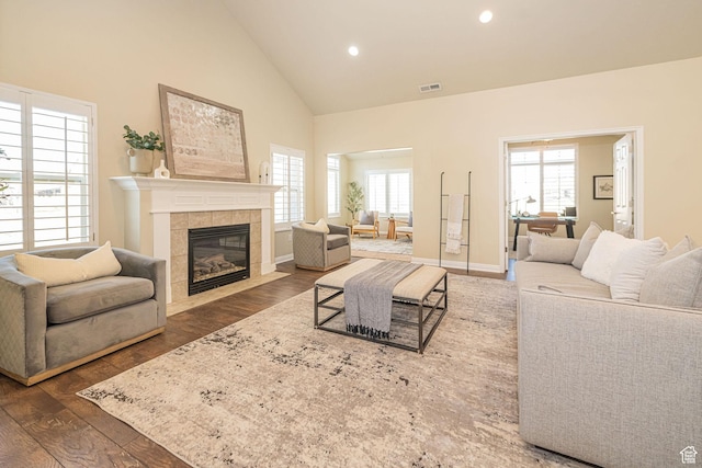 1886 S 830 W Unit D, Syracuse, UT 84075 - living area with recessed lighting, high vaulted ceiling, visible vents, a tiled fireplace, and wood finished floors